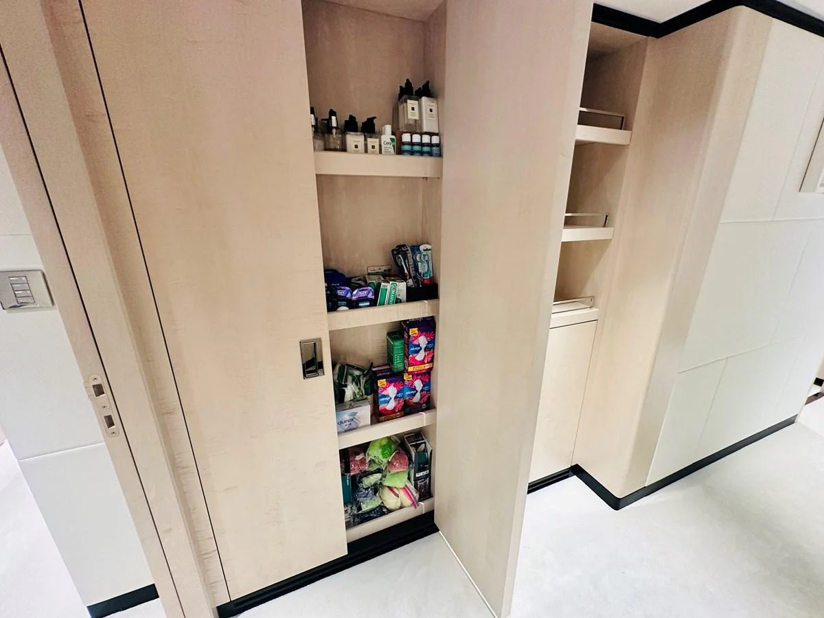 a cabinet with a shelf of bottles aboard OPTIMISM Yacht for Sale