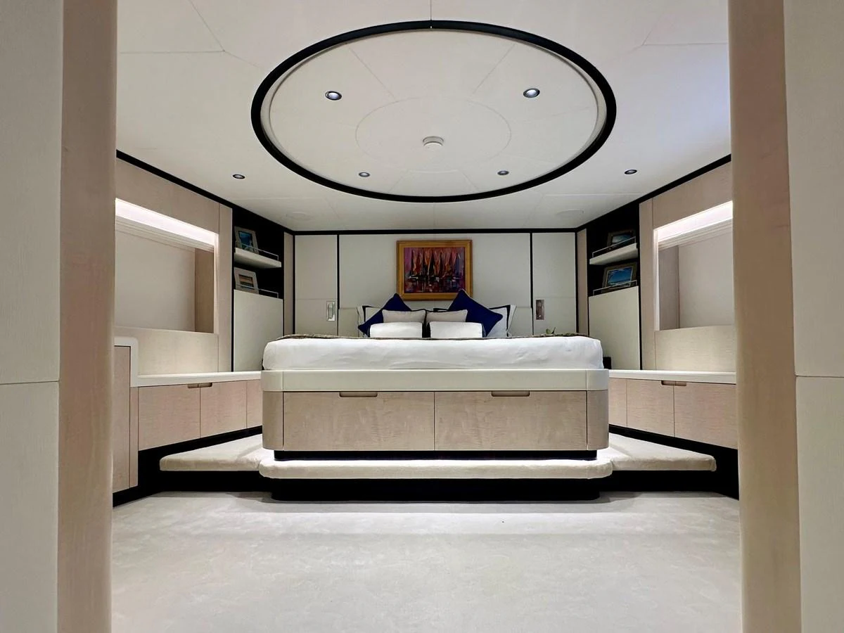 a white room with a white couch aboard OPTIMISM Yacht for Sale