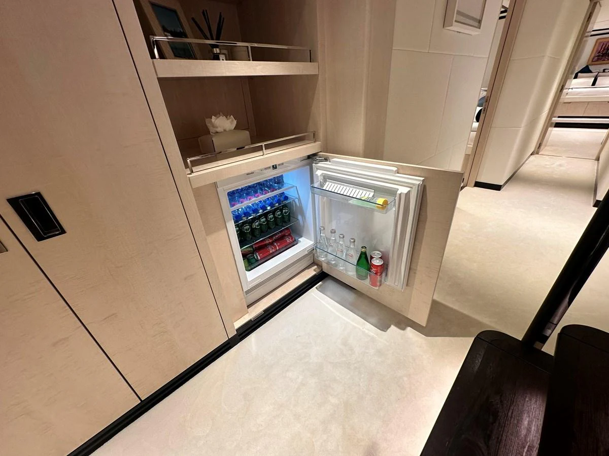 a refrigerator with a shelf of food inside aboard OPTIMISM Yacht for Sale
