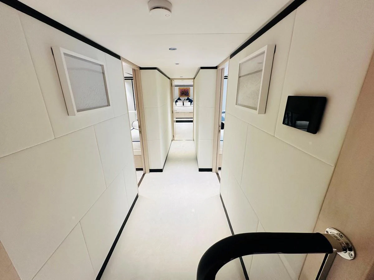 A sleek and modern hallway with elegant lighting and framed artwork. aboard OPTIMISM Yacht for Sale