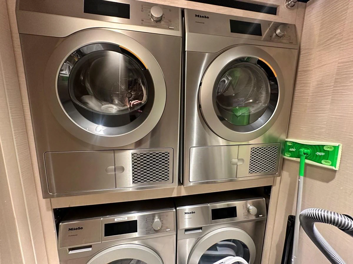 The yacht features a well-equipped laundry room with modern appliances. aboard OPTIMISM Yacht for Sale