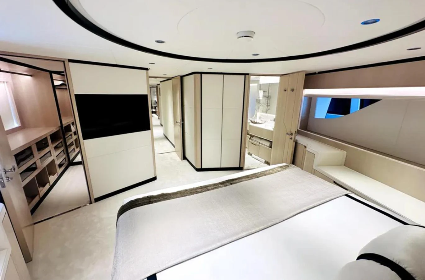 The master stateroom features a luxurious bed, ample storage, and modern design elements. aboard OPTIMISM Yacht for Sale