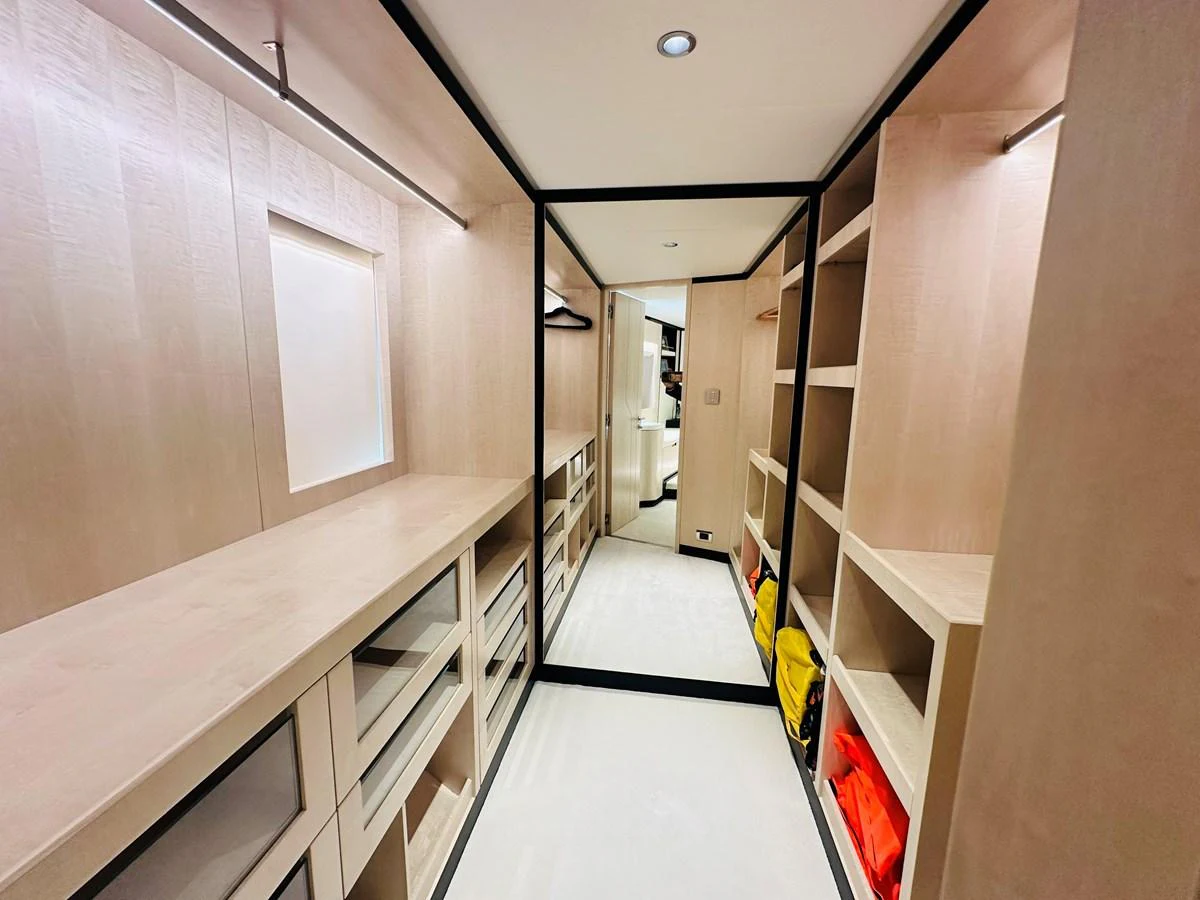 a hallway with several white cabinets aboard OPTIMISM Yacht for Sale