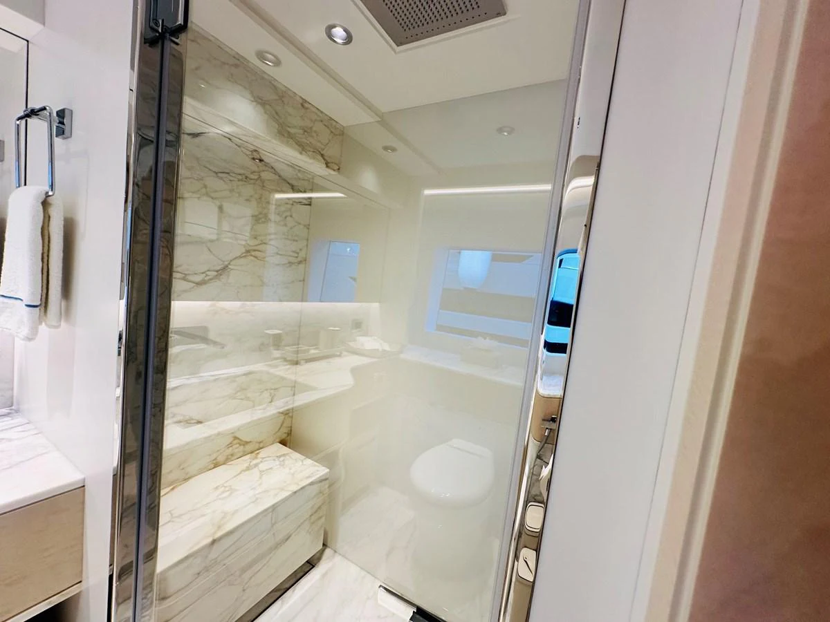 a bathroom with a glass shower aboard OPTIMISM Yacht for Sale
