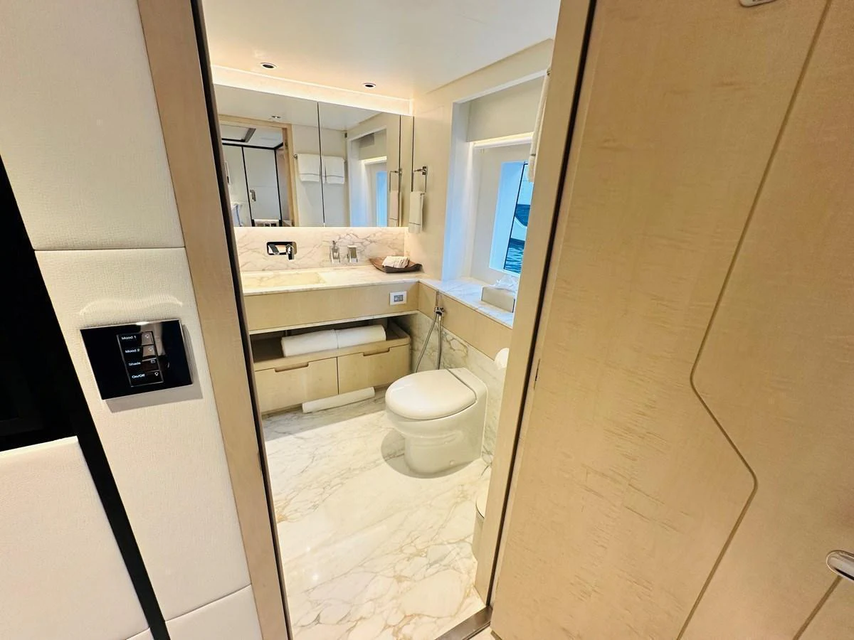 The yacht's bathroom features elegant fixtures and a luxurious marble floor. aboard OPTIMISM Yacht for Sale
