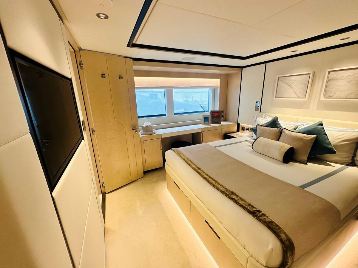 a bedroom with a bed and a tv aboard OPTIMISM Yacht for Sale