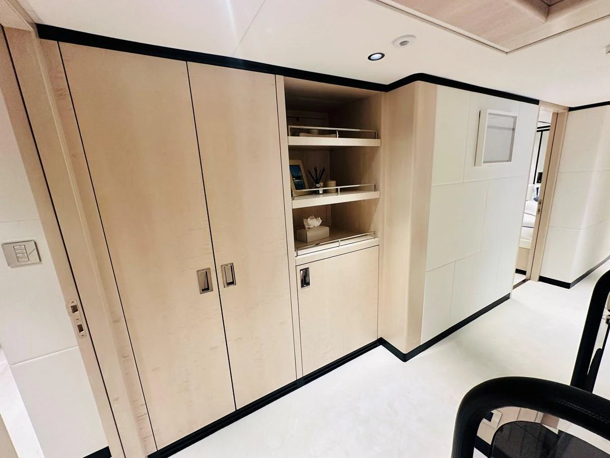 A sleek and modern interior hallway with built-in storage and elegant finishes. aboard OPTIMISM Yacht for Sale