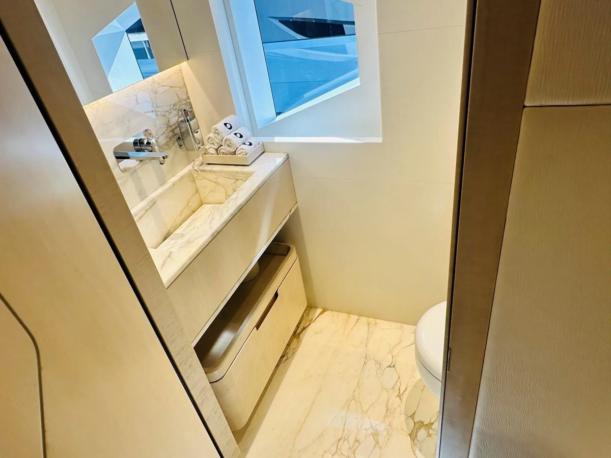 A luxurious yacht bathroom featuring elegant marble surfaces and modern fixtures. aboard OPTIMISM Yacht for Sale