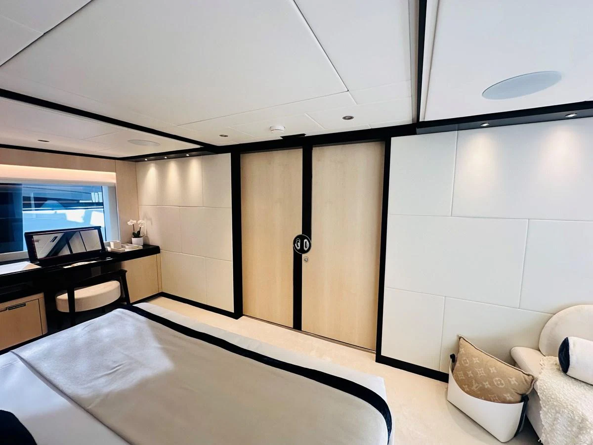 a room with a bed and a desk aboard OPTIMISM Yacht for Sale