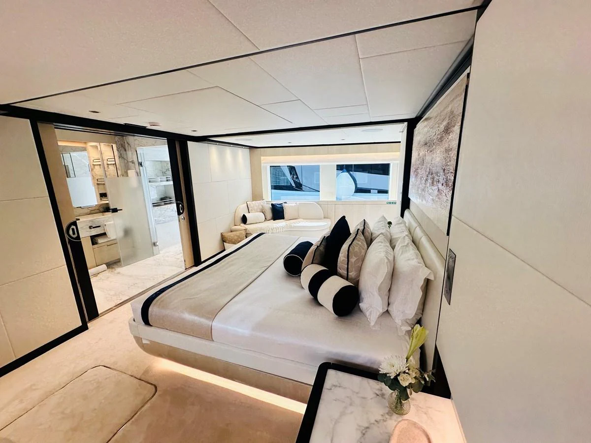 a bedroom with a large bed aboard OPTIMISM Yacht for Sale