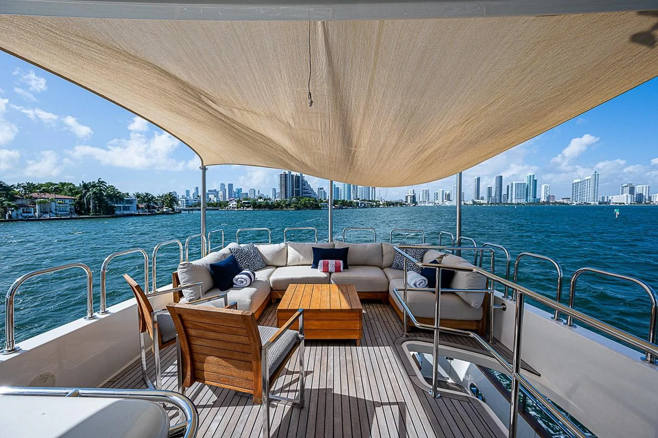a deck with a large body of water and a large city in the background aboard THE USUAL Yacht for Sale