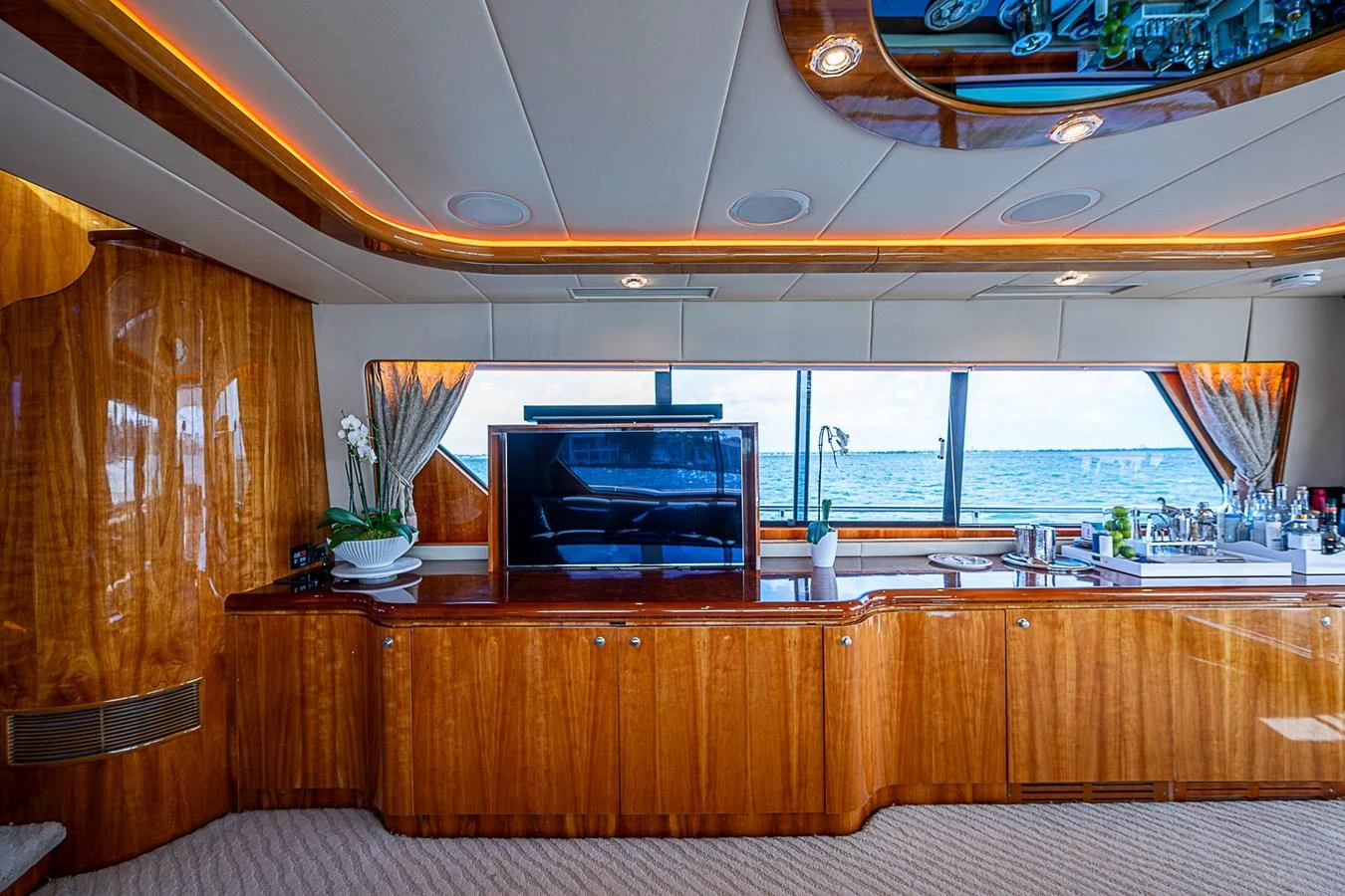 a room with a tv and a wood cabinet aboard THE USUAL Yacht for Sale