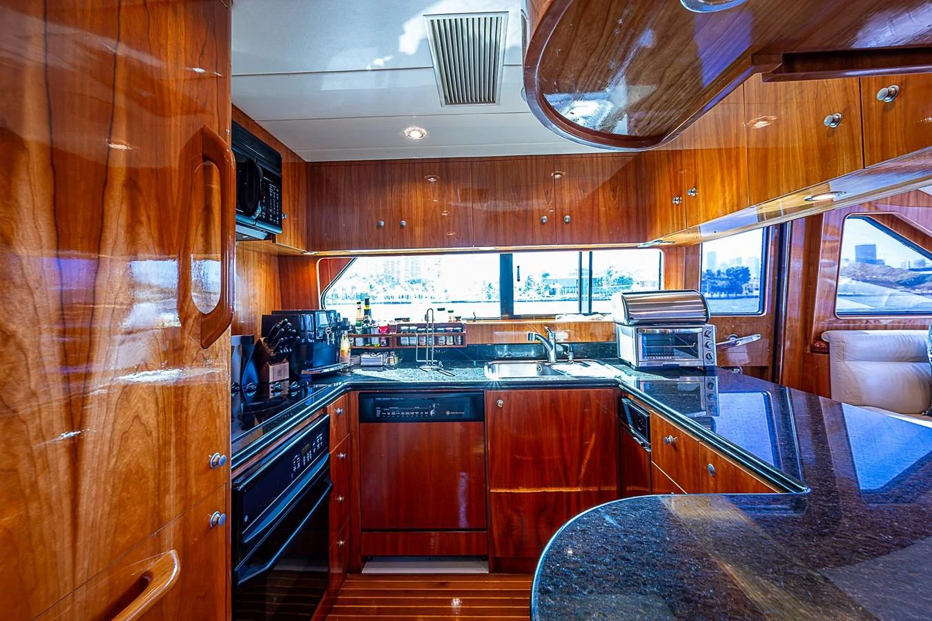 a kitchen with wooden cabinets aboard THE USUAL Yacht for Sale