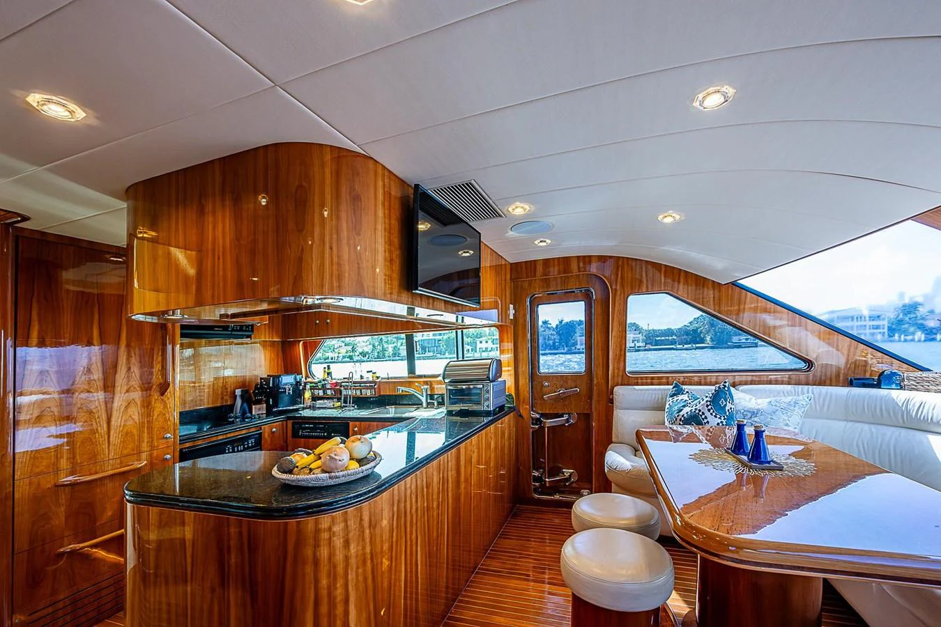 a kitchen with a table and chairs aboard THE USUAL Yacht for Sale