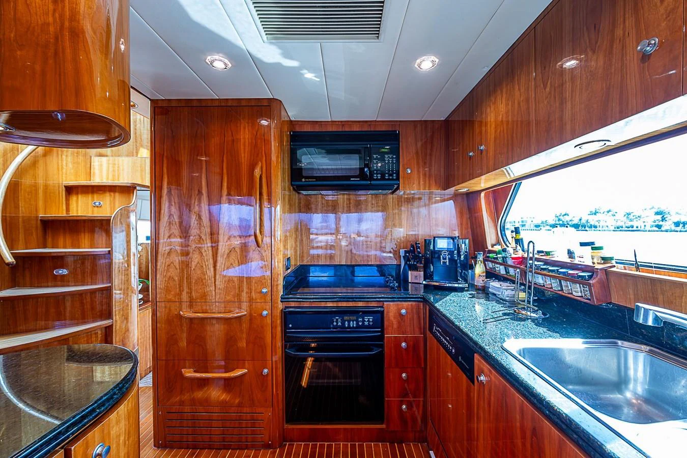 a kitchen with wooden cabinets aboard THE USUAL Yacht for Sale