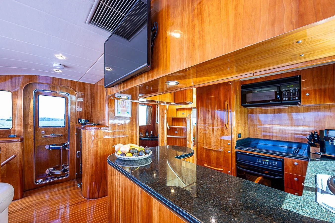 a kitchen with wooden cabinets aboard THE USUAL Yacht for Sale