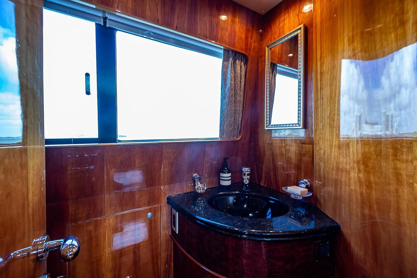 a bathroom with a sink and a window aboard THE USUAL Yacht for Sale