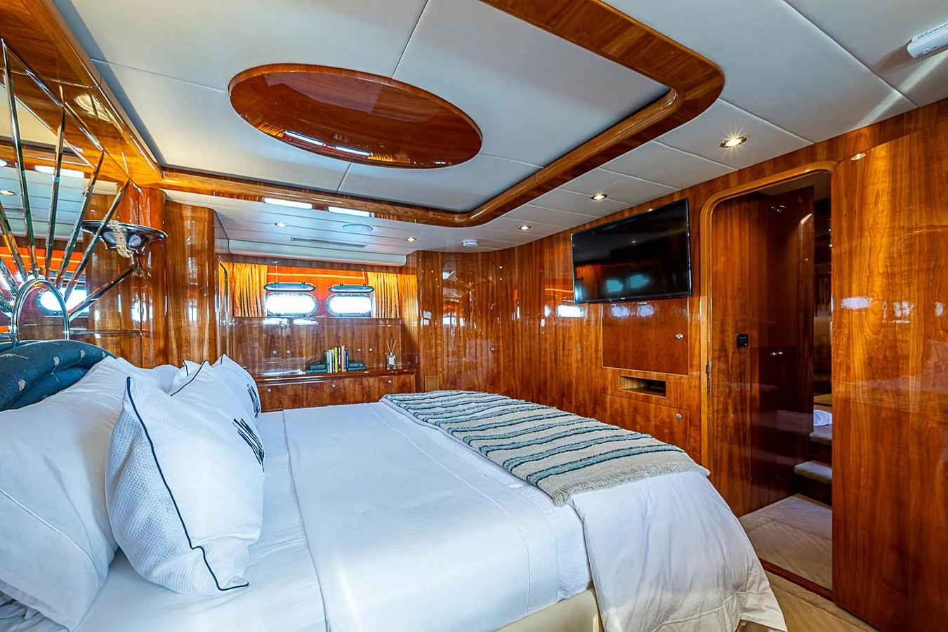 a room with beds and a ceiling fan aboard THE USUAL Yacht for Sale
