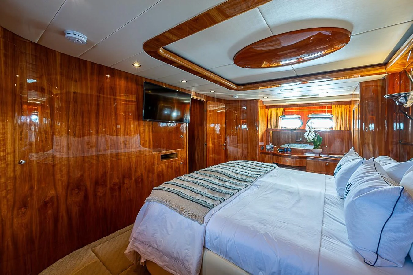 a room with wooden walls and a couple of beds aboard THE USUAL Yacht for Sale