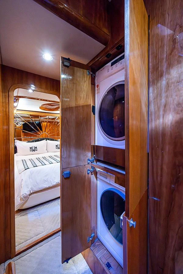a room with a bed and a mirror aboard THE USUAL Yacht for Sale
