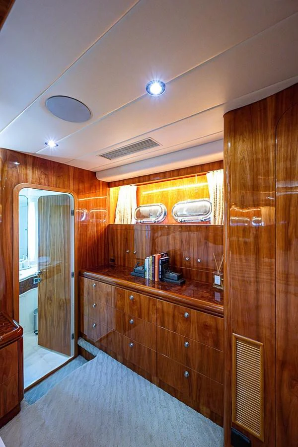 a room with a wood cabinet and a door aboard THE USUAL Yacht for Sale