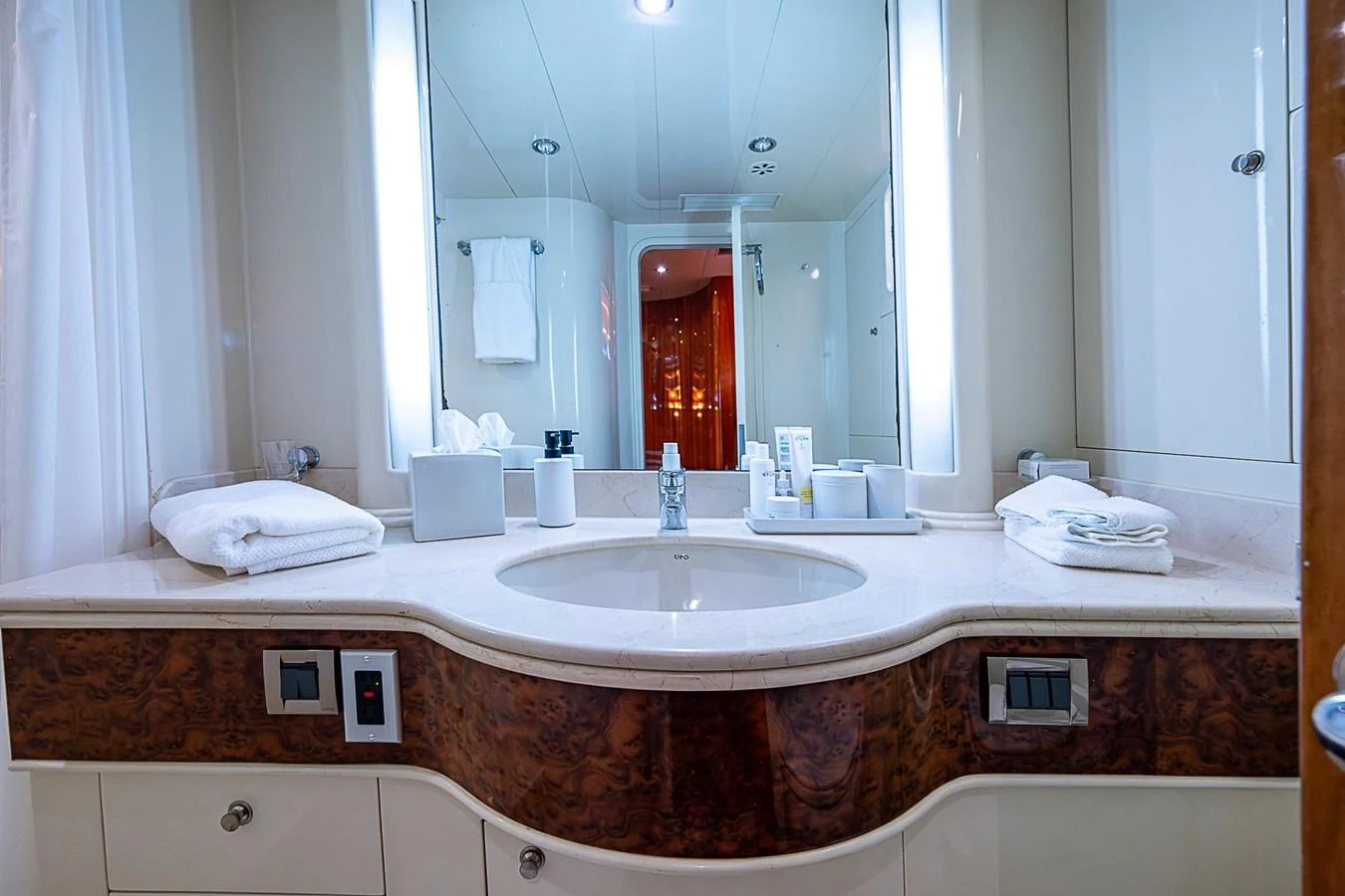 a bathroom with a large mirror aboard THE USUAL Yacht for Sale