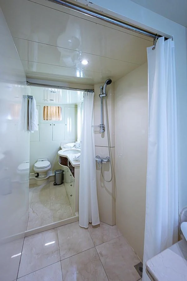 a bathroom with a standup shower aboard THE USUAL Yacht for Sale