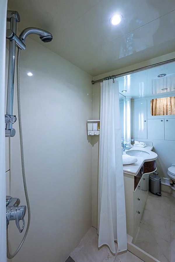 a bathroom with a shower curtain aboard THE USUAL Yacht for Sale