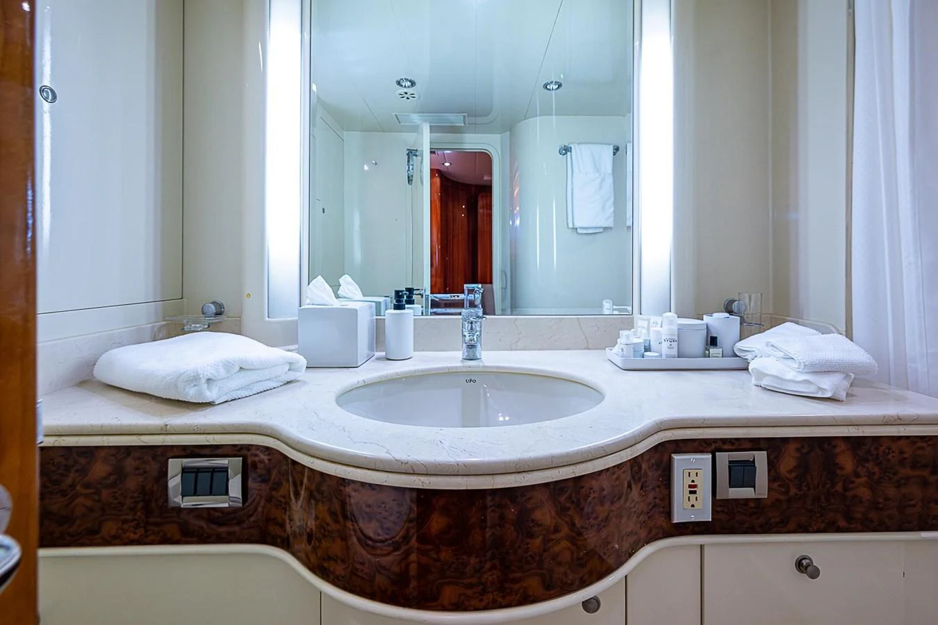 a bathroom with a large mirror aboard THE USUAL Yacht for Sale