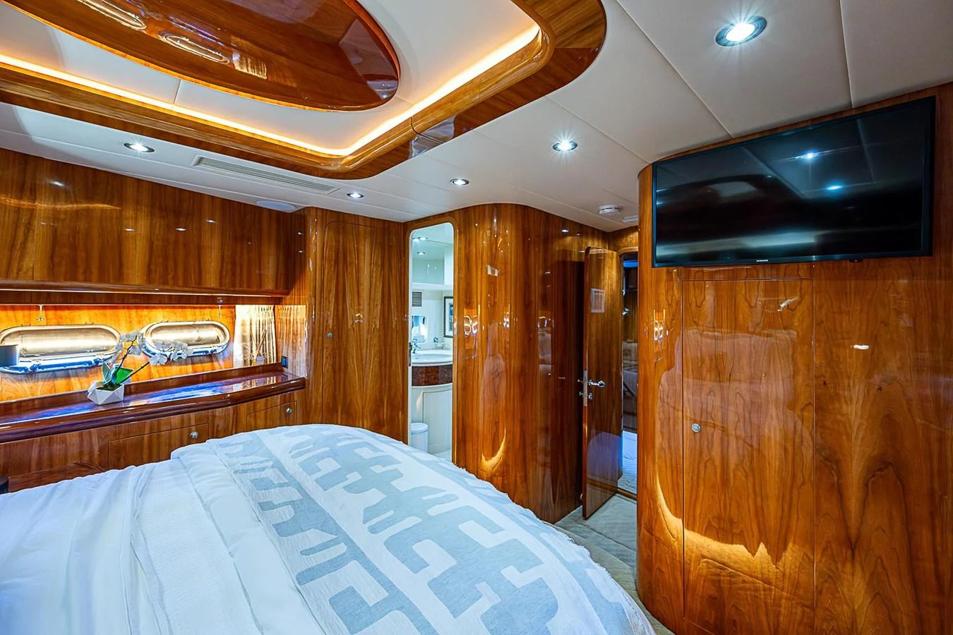 a bedroom with a bed and a television aboard THE USUAL Yacht for Sale