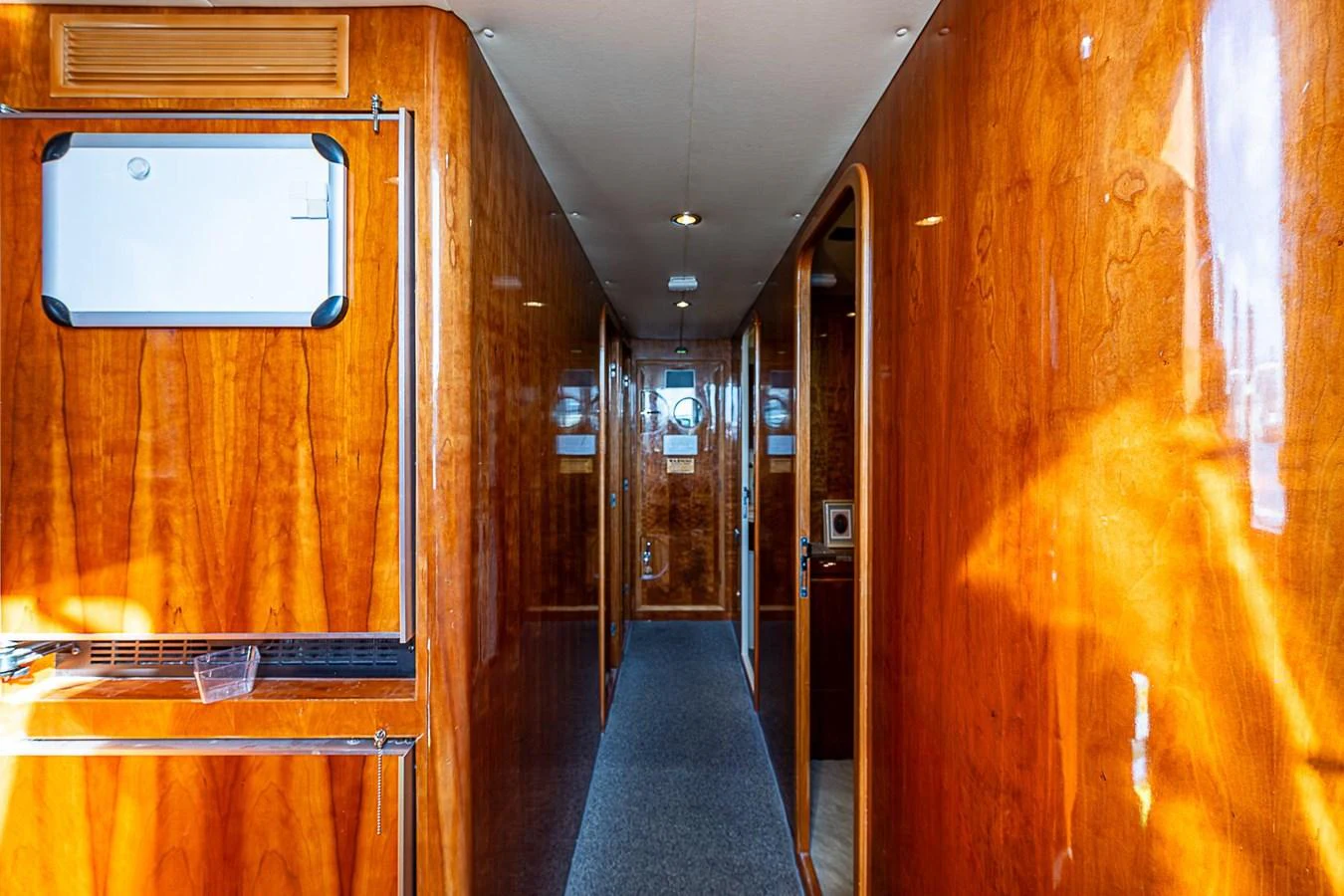 a hallway with wooden doors aboard THE USUAL Yacht for Sale