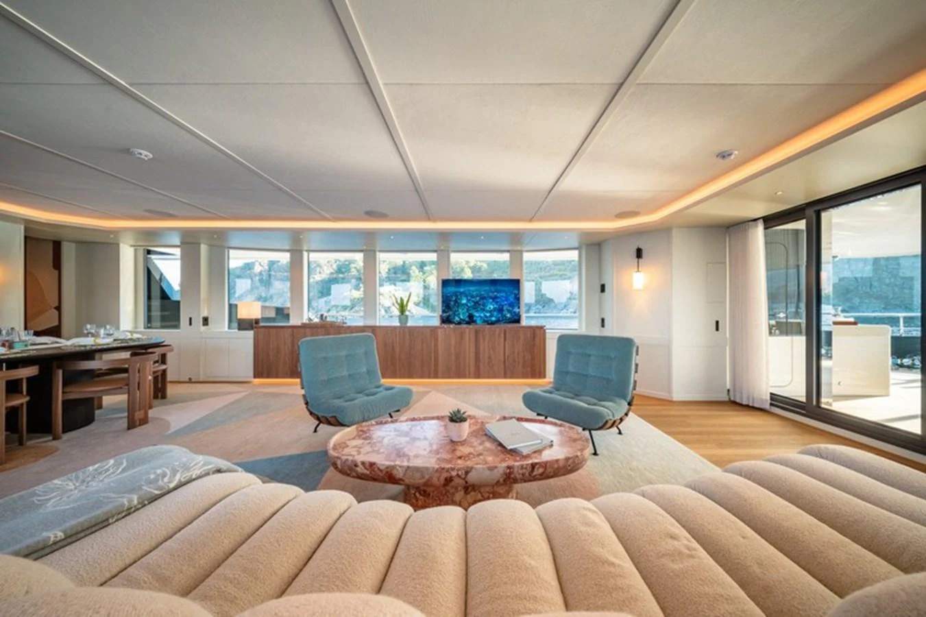 a living room with a table and chairs aboard COCOON Yacht for Sale