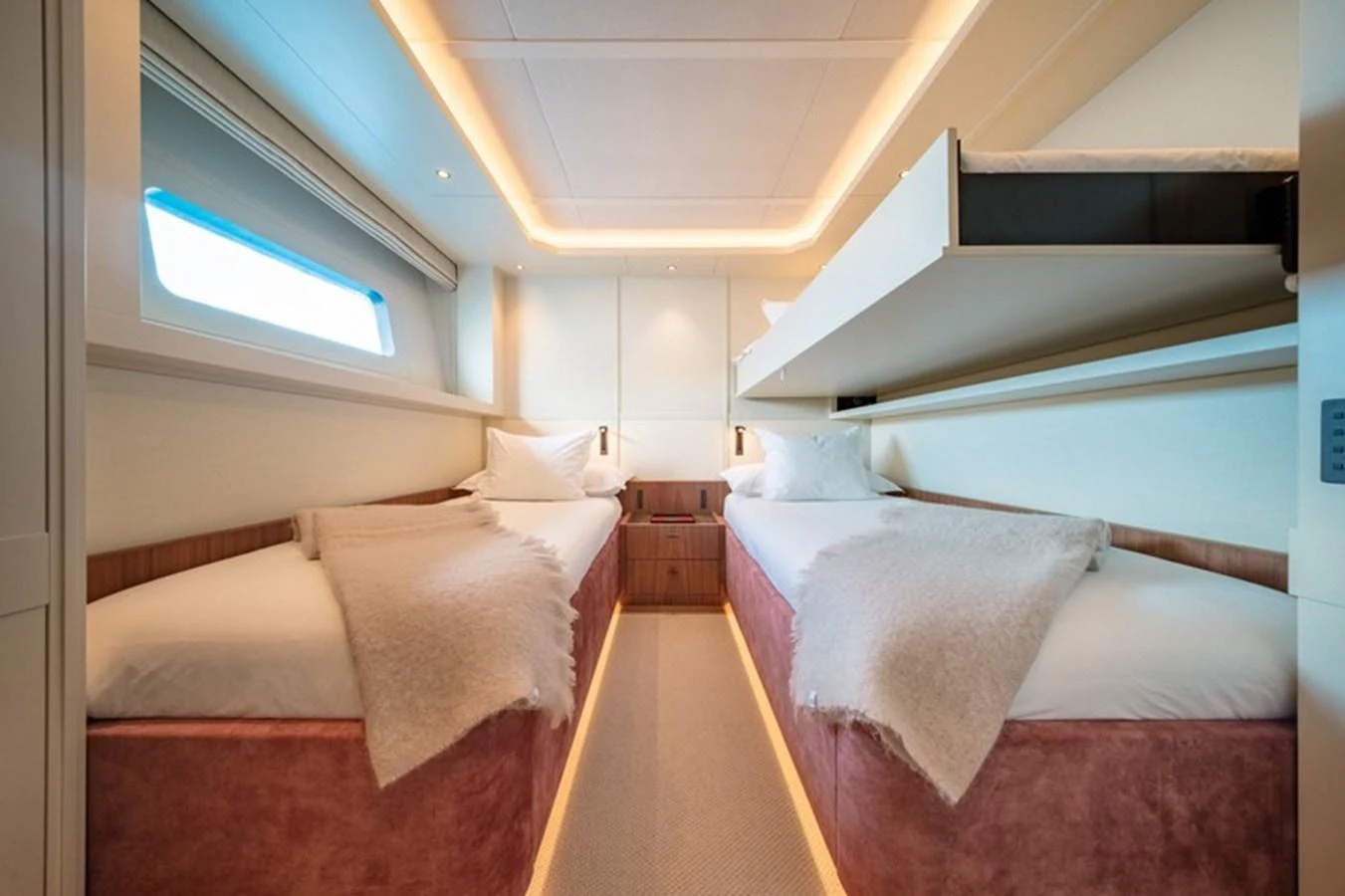 a room with beds and a window aboard COCOON Yacht for Sale