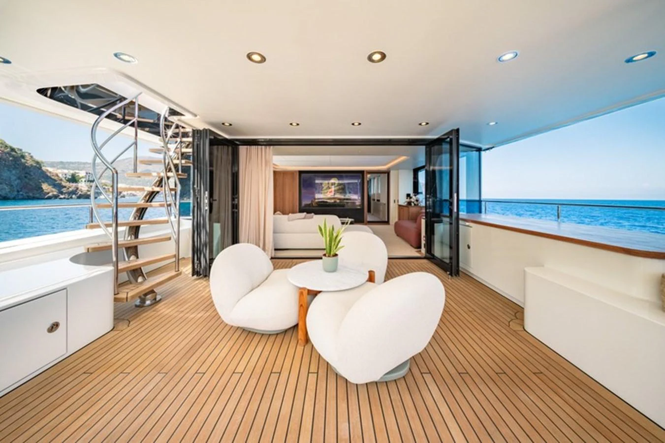 a large open living room with a large balcony aboard COCOON Yacht for Sale