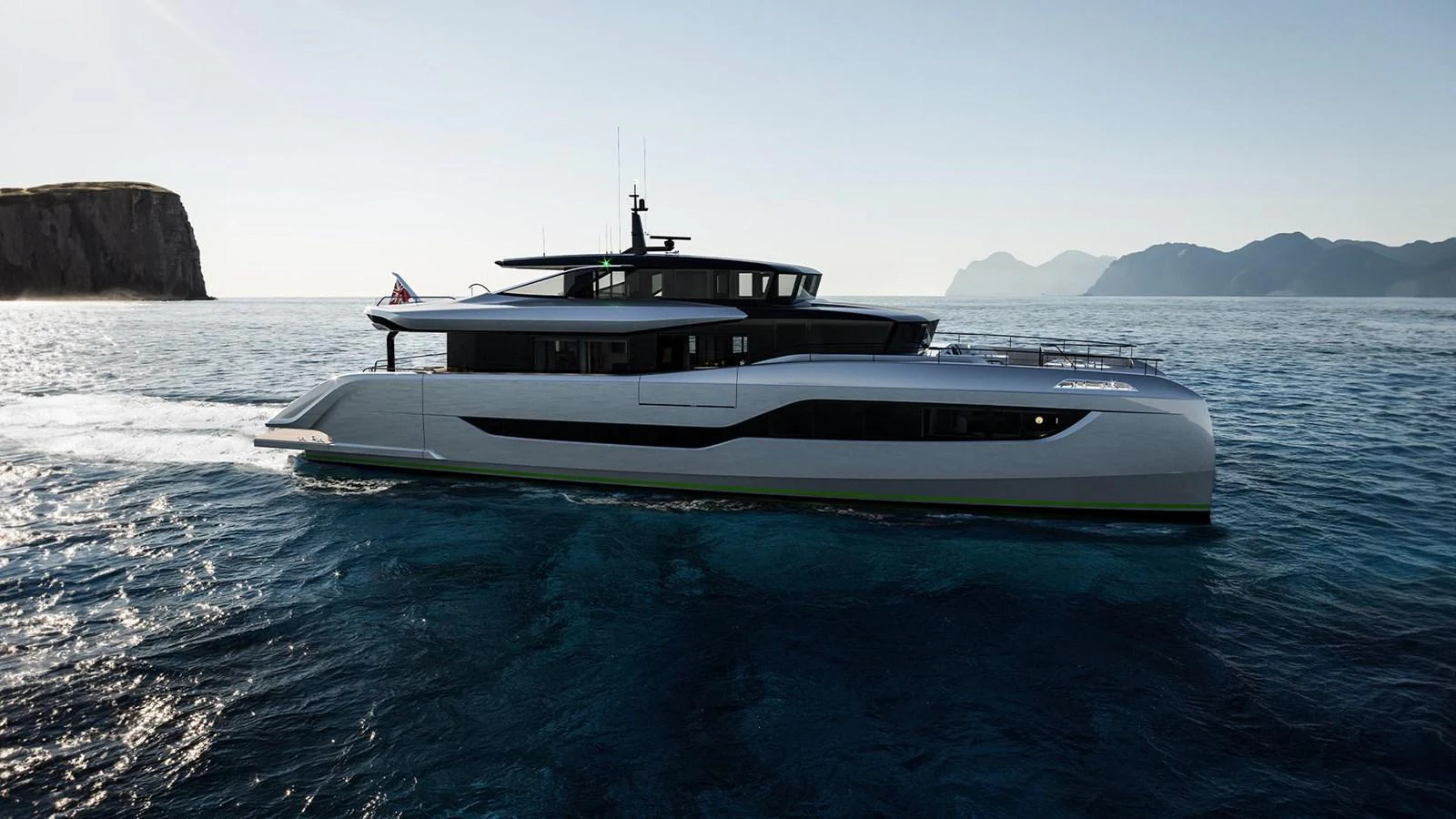 A sleek and modern yacht cruises through calm waters with a scenic mountainous backdrop. aboard ULTIMA 111 Yacht for Sale
