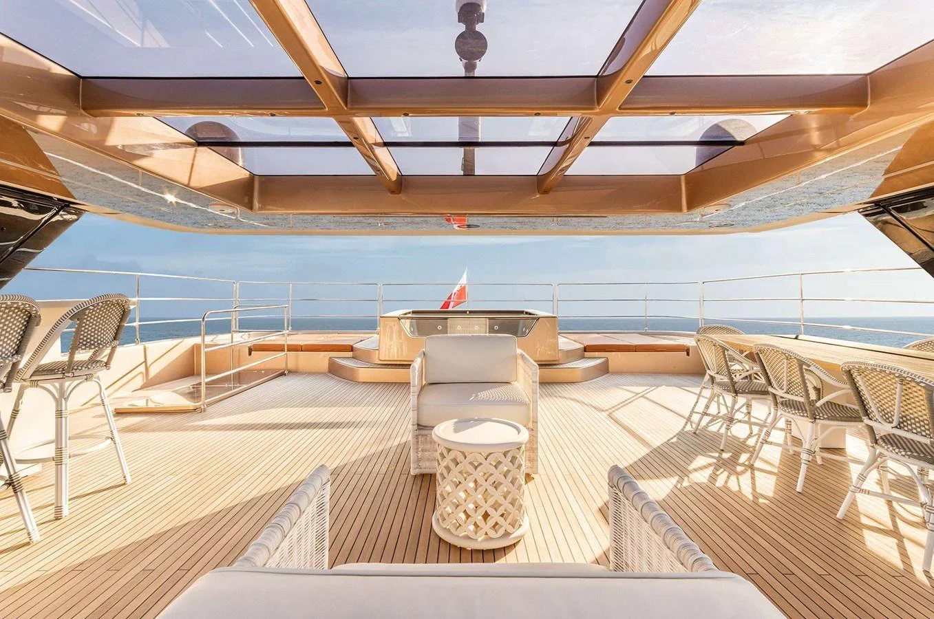 The sundeck offers a luxurious open-air space with ample seating and a stunning view of the sea. aboard 100 SUNREEF POWER NEXT Yacht for Sale