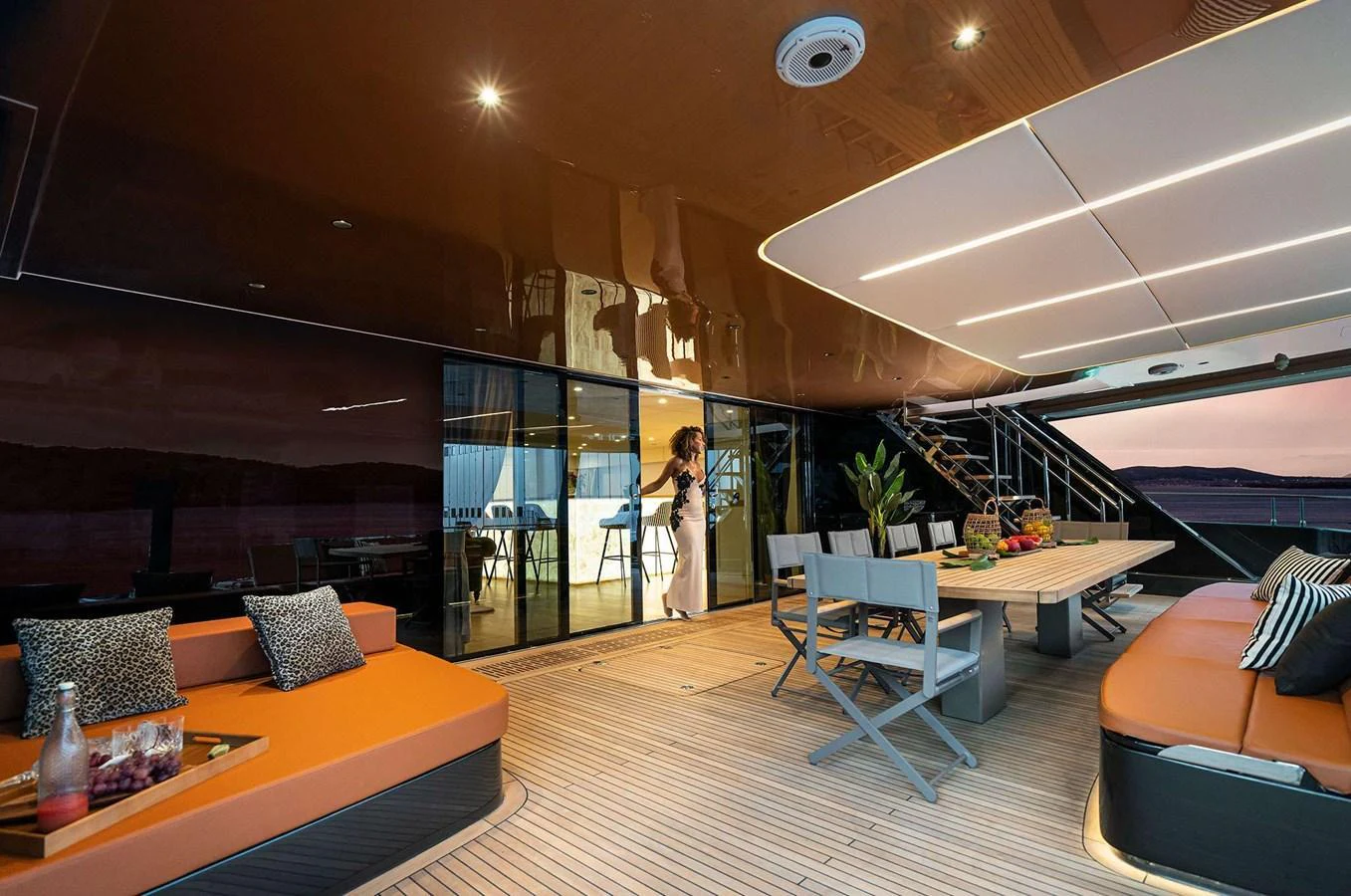 The aft deck features a spacious seating area with a dining table, perfect for enjoying meals with a view. aboard 100 SUNREEF POWER NEXT Yacht for Sale