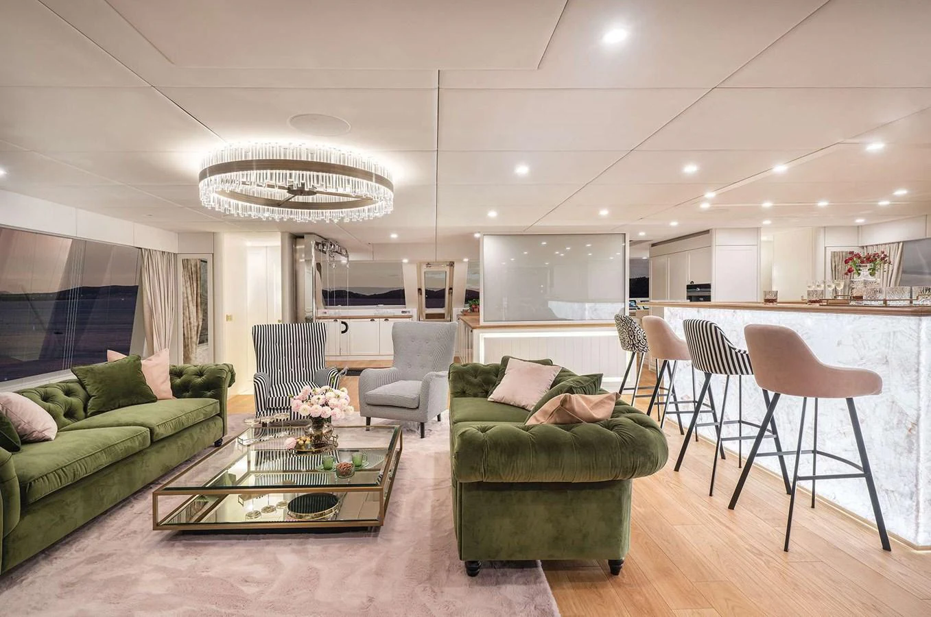 The salon features elegant seating with plush green sofas and a stylish bar area, creating a luxurious and inviting atmosphere. aboard 100 SUNREEF POWER NEXT Yacht for Sale