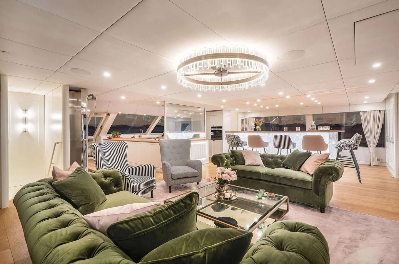 The salon features plush green seating, elegant lighting, and a spacious layout for relaxation and socializing. aboard 100 SUNREEF POWER NEXT Yacht for Sale