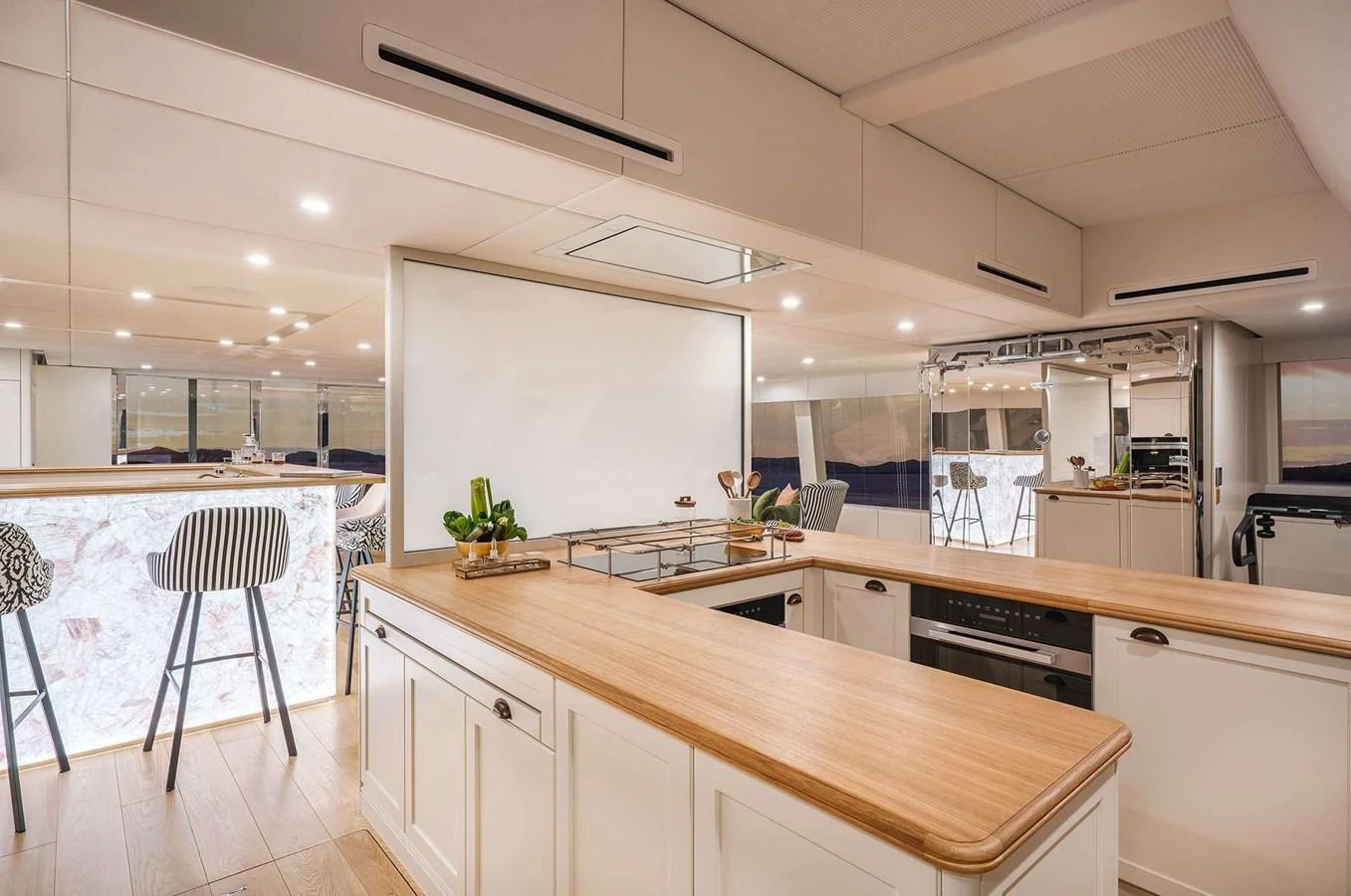 The galley features modern appliances and a spacious layout with a stylish breakfast bar. aboard 100 SUNREEF POWER NEXT Yacht for Sale