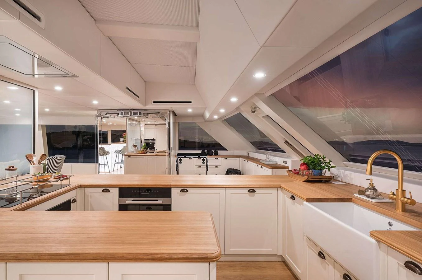The yacht's galley features modern appliances and a spacious layout with ample natural light. aboard 100 SUNREEF POWER NEXT Yacht for Sale