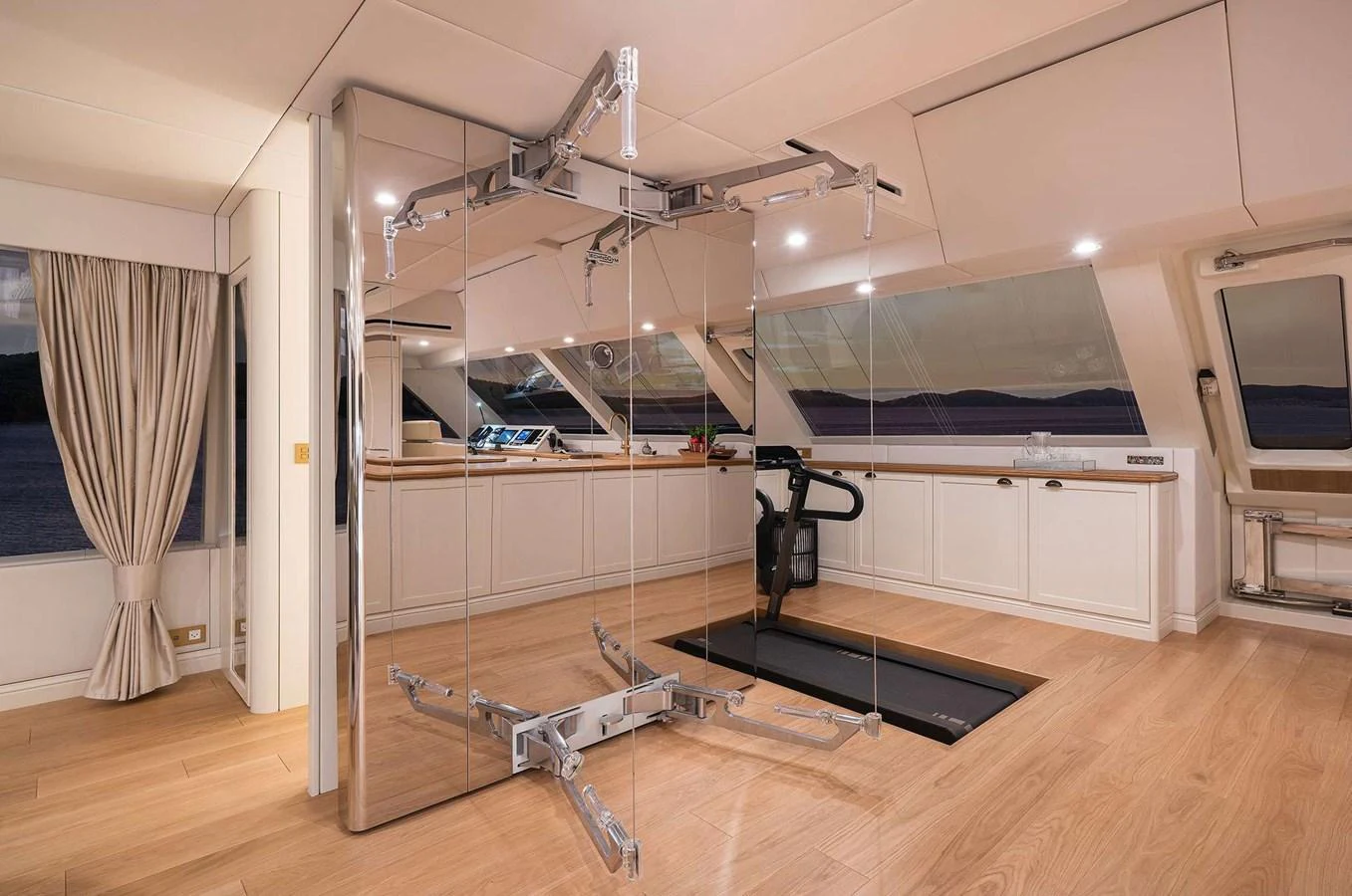 The yacht's interior gym features modern exercise equipment and large windows for an inspiring workout environment. aboard 100 SUNREEF POWER NEXT Yacht for Sale