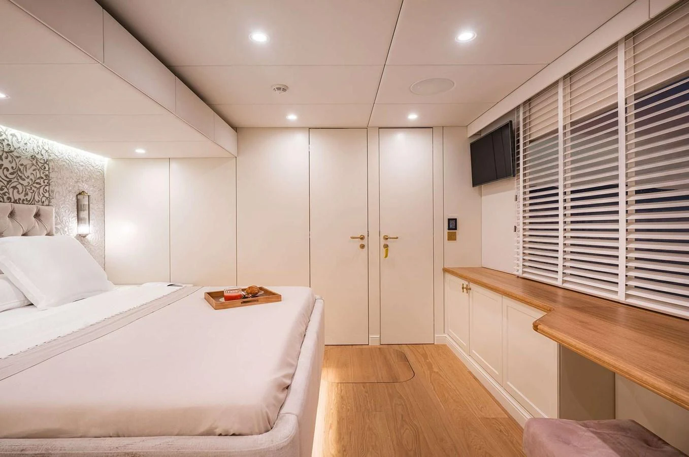 The stateroom features a luxurious bed, elegant decor, and ample natural light. aboard 100 SUNREEF POWER NEXT Yacht for Sale