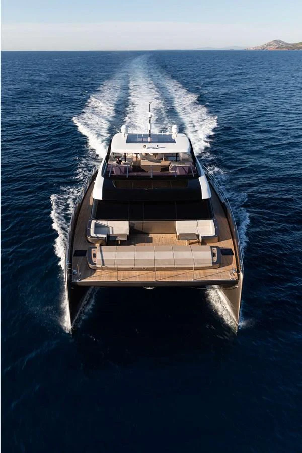 A sleek yacht cruises through the open sea, showcasing its modern design and spacious deck areas. aboard 80 SUNREEF POWER NEXT Yacht for Sale
