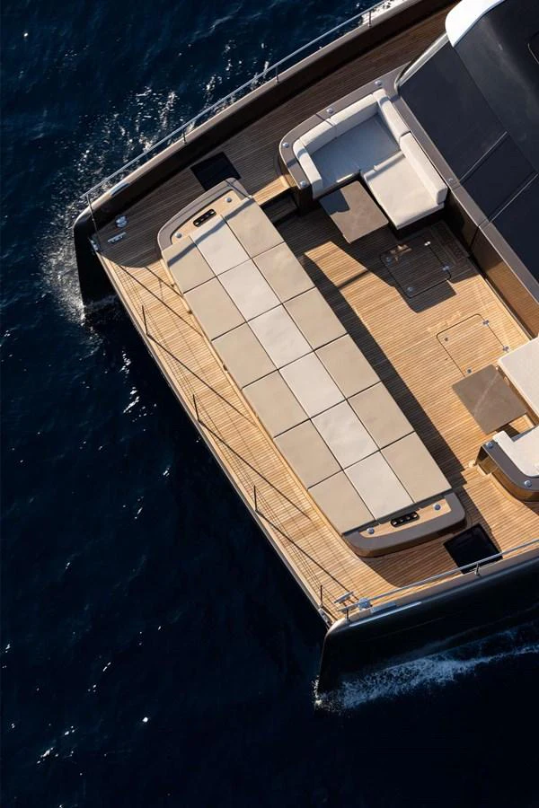 The aft deck features a spacious lounging area with elegant seating and a large table, perfect for outdoor relaxation and dining. aboard 80 SUNREEF POWER NEXT Yacht for Sale