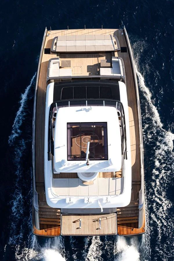 An aerial view of a luxurious yacht cruising through the water, showcasing its spacious deck and sleek design. aboard 80 SUNREEF POWER NEXT Yacht for Sale