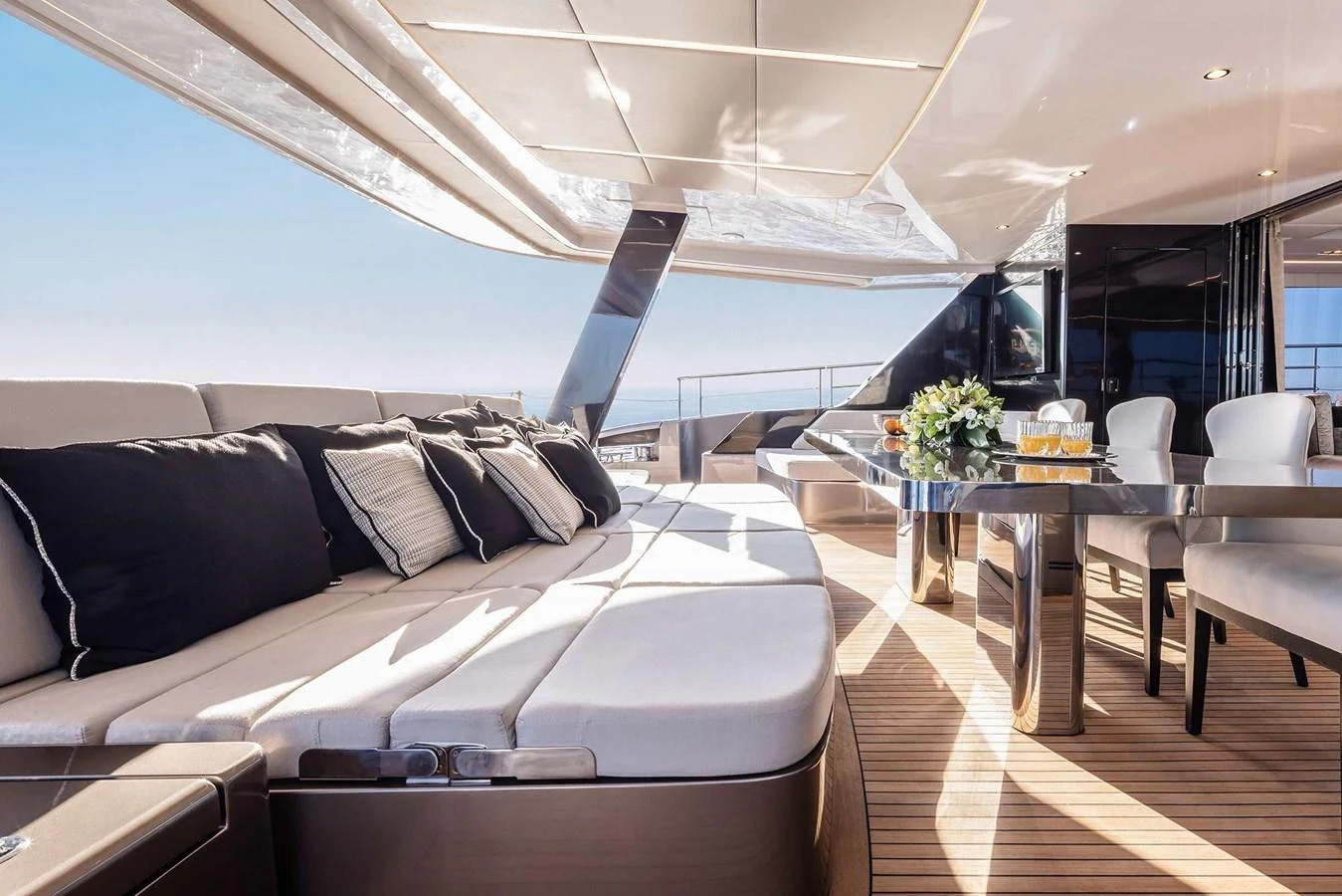 The aft deck offers a luxurious lounging area with plush seating and a stylish dining table, perfect for alfresco dining and relaxation. aboard 80 SUNREEF POWER NEXT Yacht for Sale
