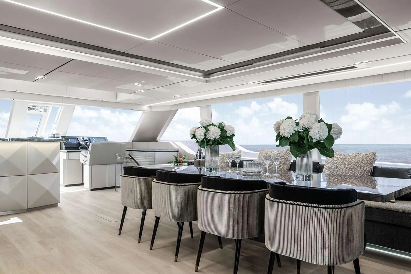 The yacht's dining area features a sleek, modern design with ample natural light and elegant decor. aboard 80 SUNREEF POWER NEXT Yacht for Sale