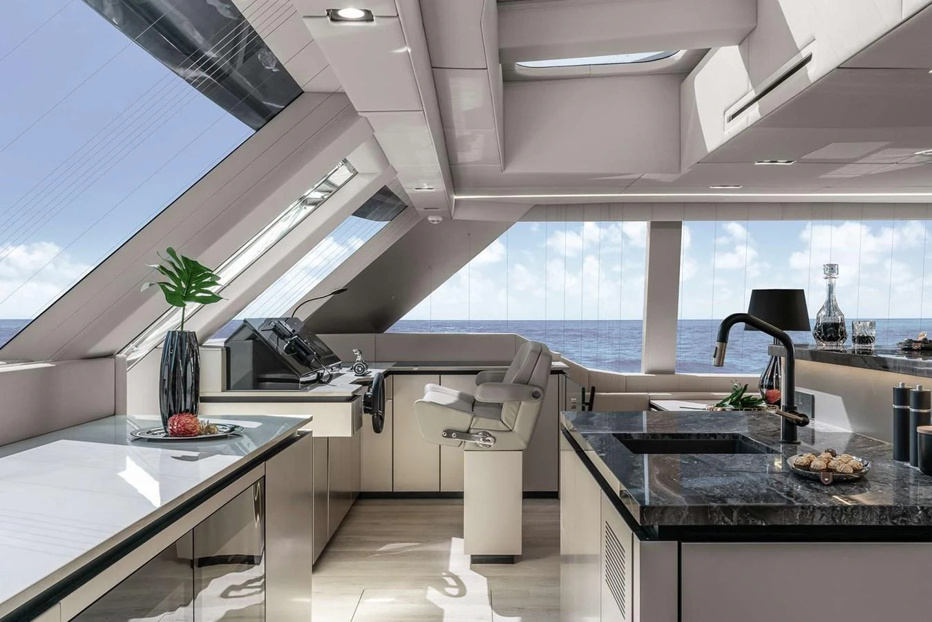 The modern galley features sleek countertops, ample natural light, and a stunning ocean view. aboard 80 SUNREEF POWER NEXT Yacht for Sale