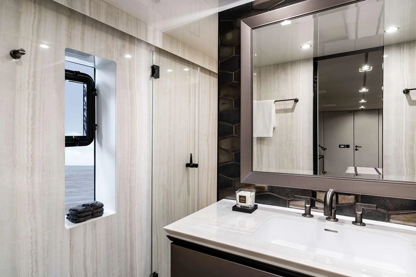 A sleek and modern yacht bathroom featuring a large mirror and elegant fixtures. aboard 80 SUNREEF POWER NEXT Yacht for Sale